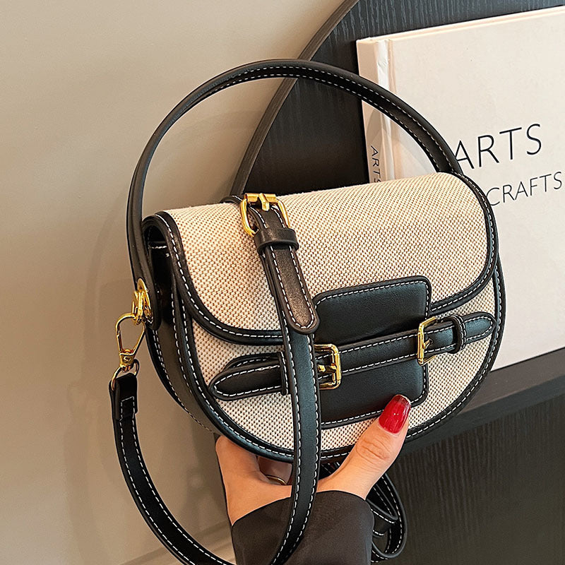Black and natural Sola Saddle Bag handheld closeup
