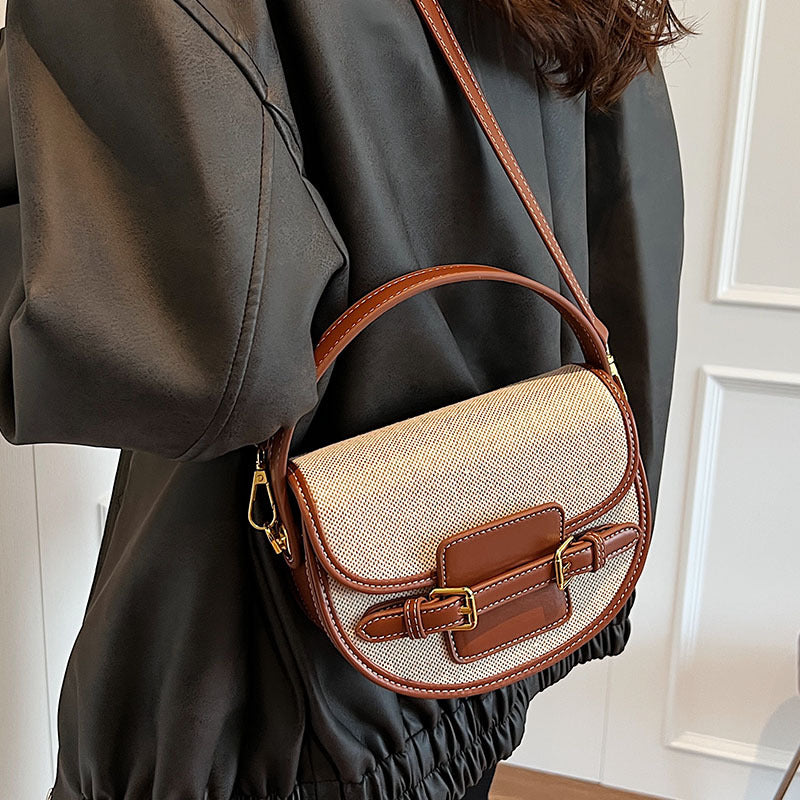 Natural and brown Sola Saddle Bag worn crossbody