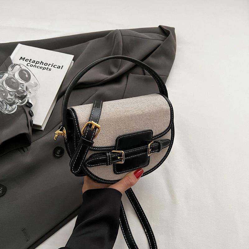 Black and natural Sola Saddle Bag styled product angle