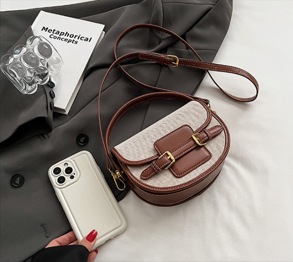 Natural and brown Sola Saddle Bag with phone for scale