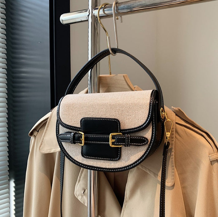Black Sola Saddle Bag styled on coat